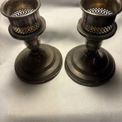 Pair of sterling silver candleholders, both have dents and need polishing