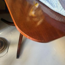 Traditional pedestal-style dining table with classic curved legs and a polished wood finish