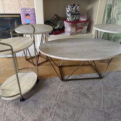 Four piece set includes one coffee table 2 end tables, one bar cart
