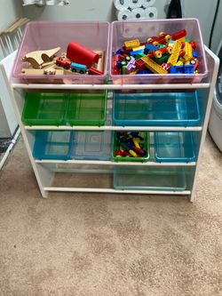 Children’s wooden four level, multi divided toy organizer.