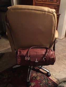 Log shaped brown leather handbag