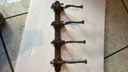 Cast-iron wall hanging coat rack with ornate hooks