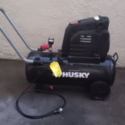 Husky 8-Gallon Portable Electric Air Compressor (specifically Model #0300816). It is a "hotdog" style unit designed for portability and light-to-mediu