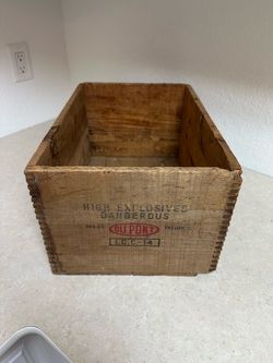 Vintagea 1953 wooden DuPont Explosives crate with stenciled markings.
