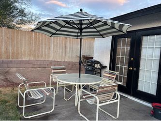 Patio table and 4 chairs with brand new 9ft umbrella,can deliver