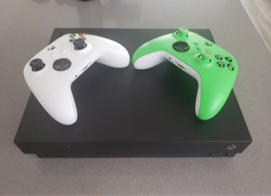Xbox One X with 5 Games, 2 Controllers, And Carrying Case