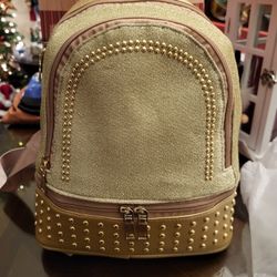 Gold silver & red small carry on backpack. Has 3 zipper compartments. New with tags ready to gift$10
