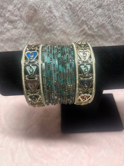 set features vibrant teal glass bangles accented