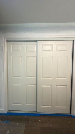 Sliding closet door with rail