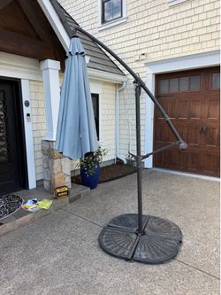 Outdoor umbrella with stand and weights. Good condition.