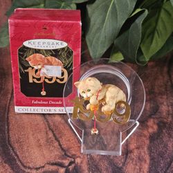vintage Hallmark Keepsake Christmas Ornament 1999 orange tabby Kitty Cat with a gold bell hanging approximately 2" x 1 1/2" *C