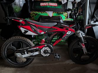 Two kids dirt  bike bicycles with training wheels