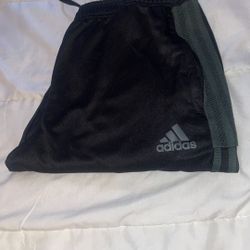 Adidas Black and Green Stripes track pants with zipper on the bottom leg. 