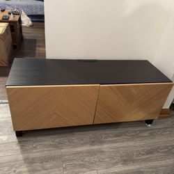 TV console IKEA has two doors with a shelf. It measures 4 feet wide, 18 inches deep, and 19 inches high. Great condition.