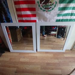 Two white frame mirrors