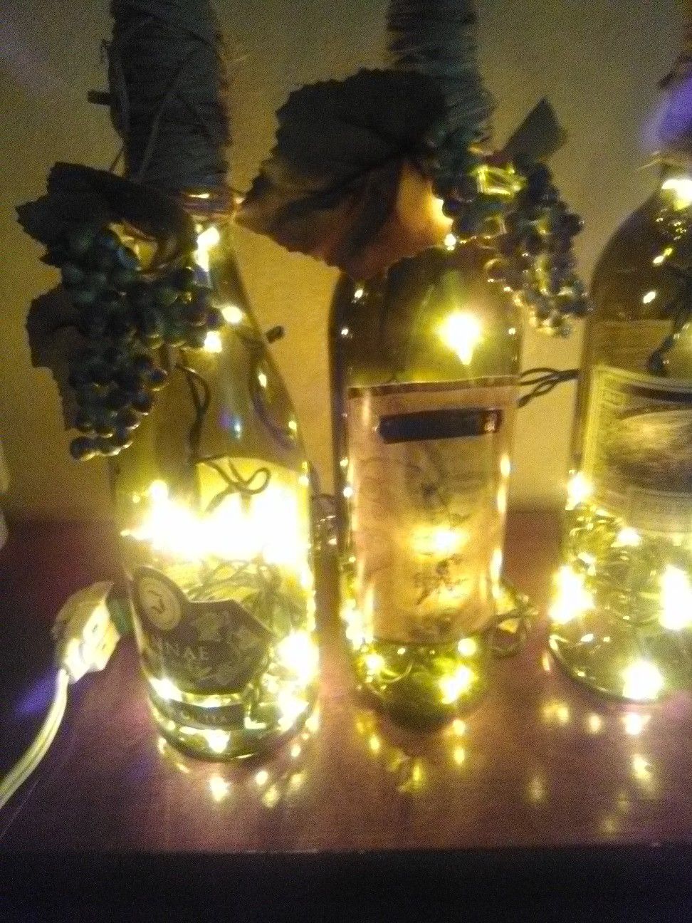 *A set of 4 Wine bottle decorations light up the room