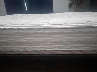 White bed frame and mattress