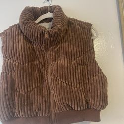 This is a Miss Posh brown corduroy puffer vest with a sherpa lining. 