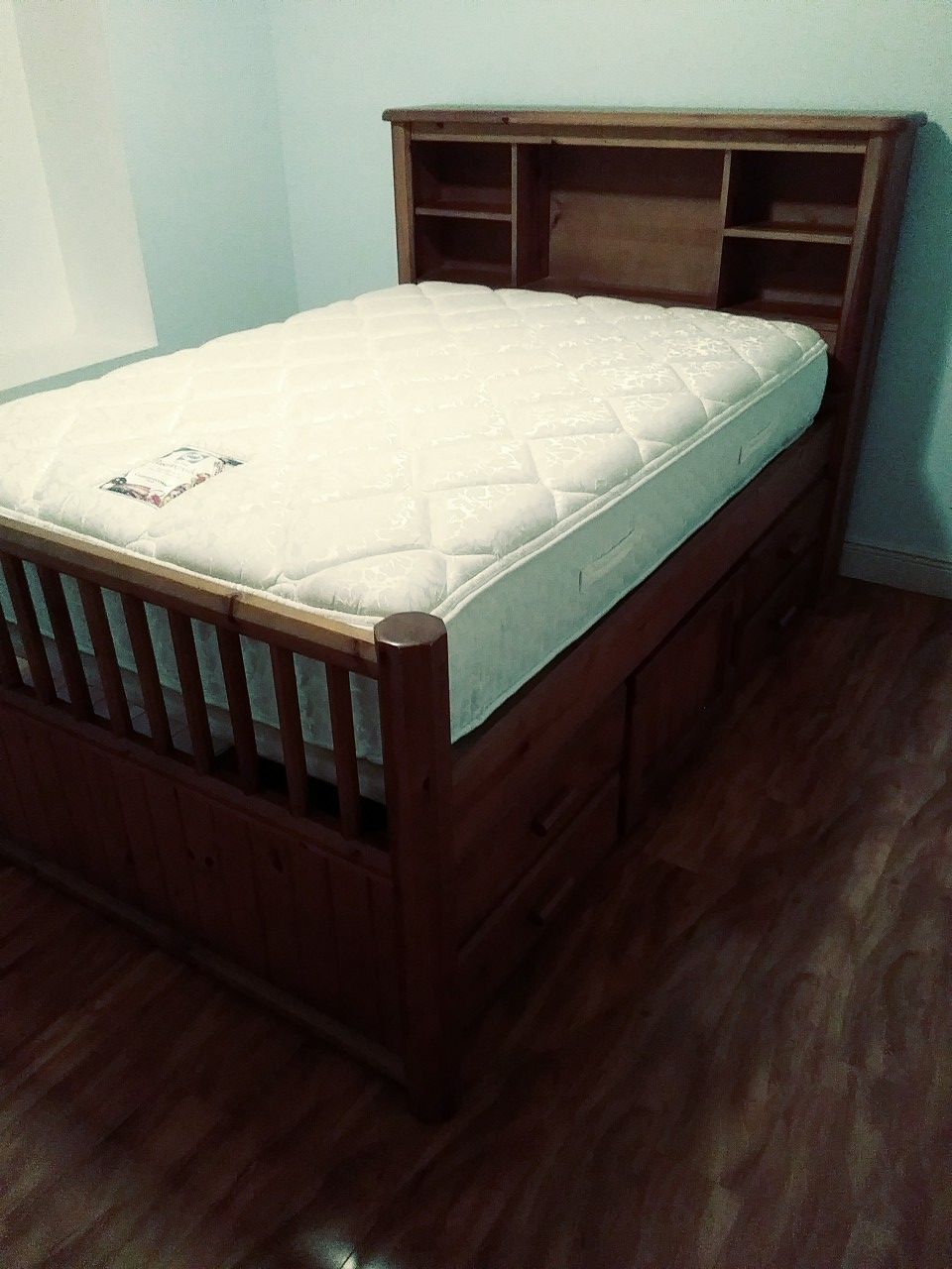 Full size bed with shelves and drawers and storage