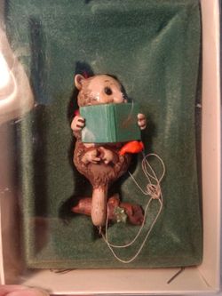 1981 Hallmark Keepsake "Topsy Turvy Tunes" ornament featuring a reading opossum.