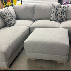 Drayden Fabric Sectional with Ottoman  Retails for over $1,400  Features: Pocket Coil Seat Cushion Sinuous Spring Seat Support Solid Wood Legs Inc