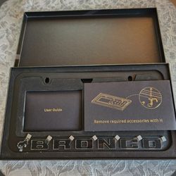 This premium license plate frame is crafted from matte black aluminum with bold raised lettering and a sleek, modern profile. It includes a full set o