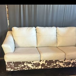 Real leather couch with cow print accent