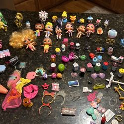 A Lot Of Different Kinds Of Little Dolls 