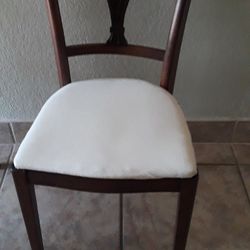 Two wooden table chairs