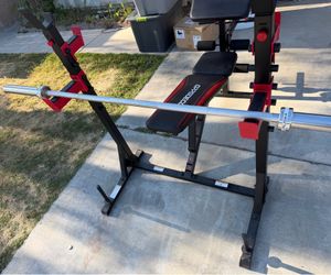 Very nice looking Olympic weight bench that can adjust to 6 positions and brand new 6 ft Olympic barbell