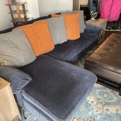 Blue Couch With Orange And Grey Pillows