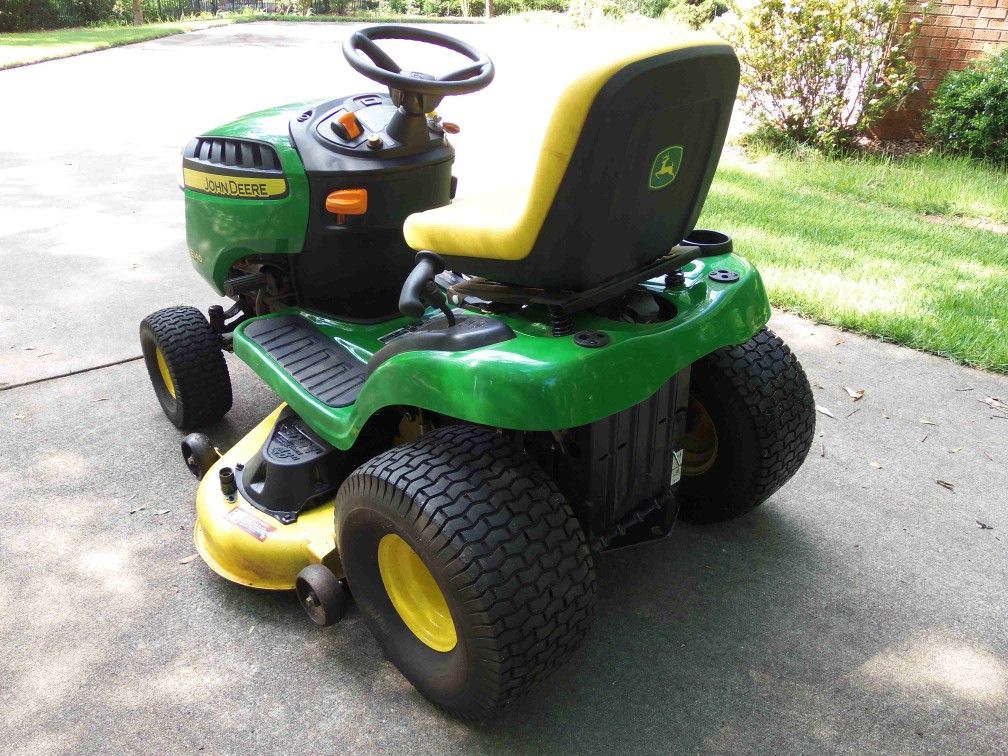 Almost new John Deere E140 riding mower only 28.1 hrs. 6yr warranty for