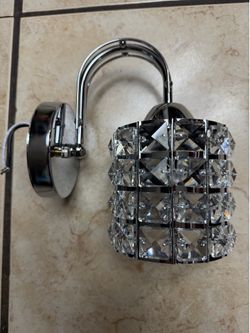 New glass and chrome wall sconce or wall mounted light.