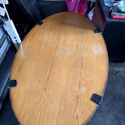 Set oval coffee table and side table featuring a wooden top and lower shelf supported