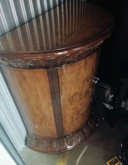 Carved wood half-round cabinet
