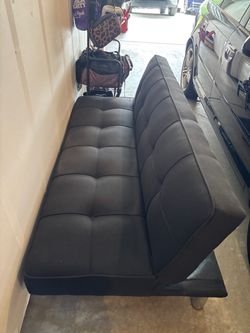 Black futon with outlets