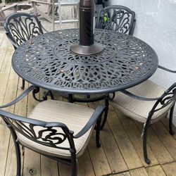 cast iron table and 4 chairs (heater not included)