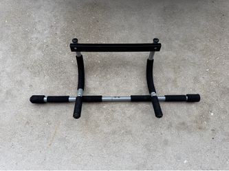 Iron Gym Total Upper Body Workout Bar, designed to fit doorways without requiring screws or drilling.