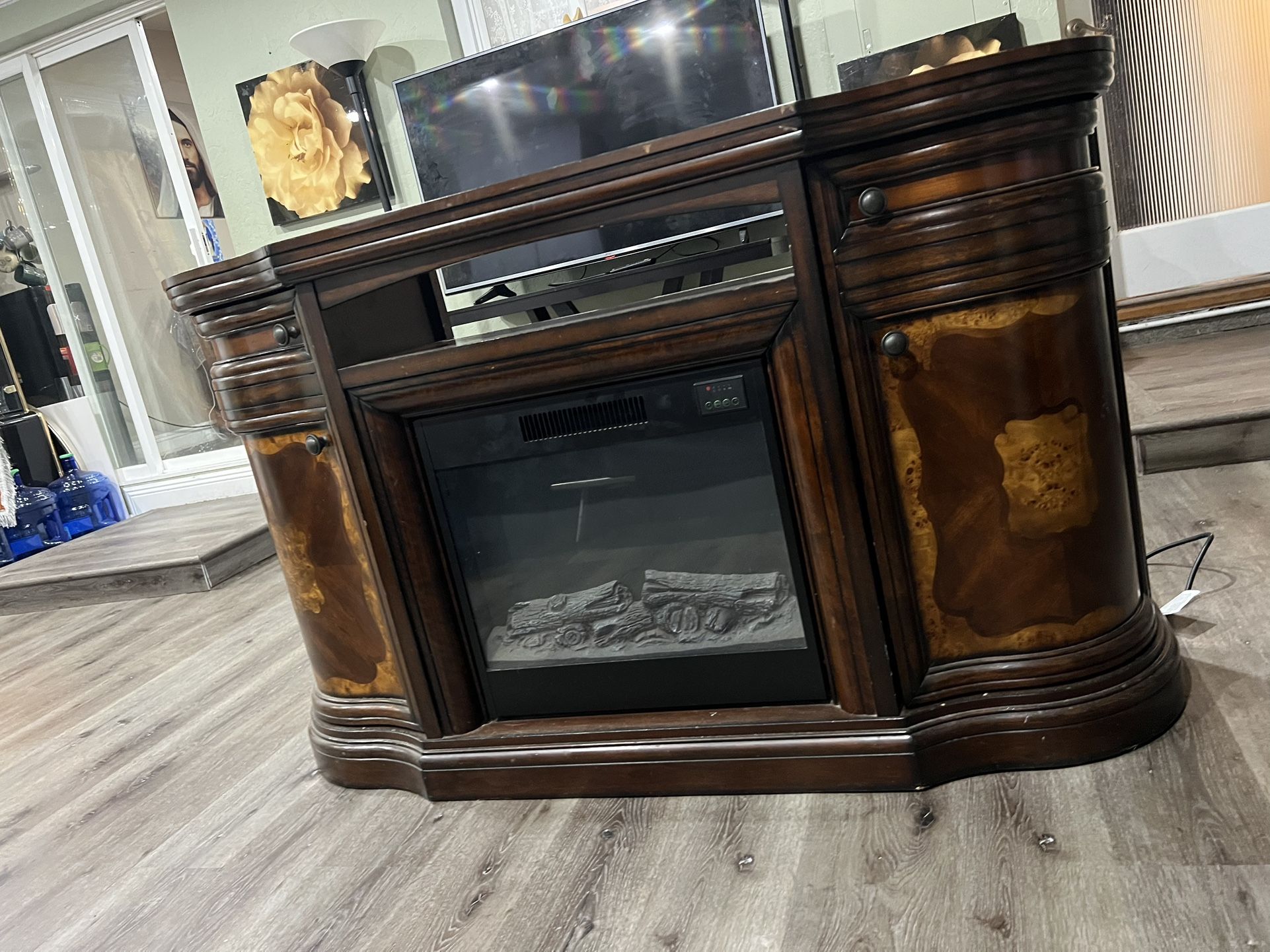 TV stand with electric fireplace.