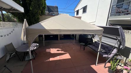 10x10 ft light beige color canopy Comes with travel case and sandbags (unfilled). In like new condition