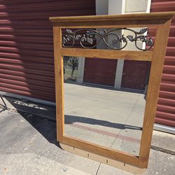 Mirror with frame is 47 in x 35 in 
Mirror alone is 32 in x 29 in 
Has holes on the bottom for attaching the dresser 
Metal decoration.