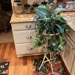 Tall shabby metal plant stand with artificial greenery included stand 34. Tall with greenery 48 tall,very sturdy ,solid ready to use .