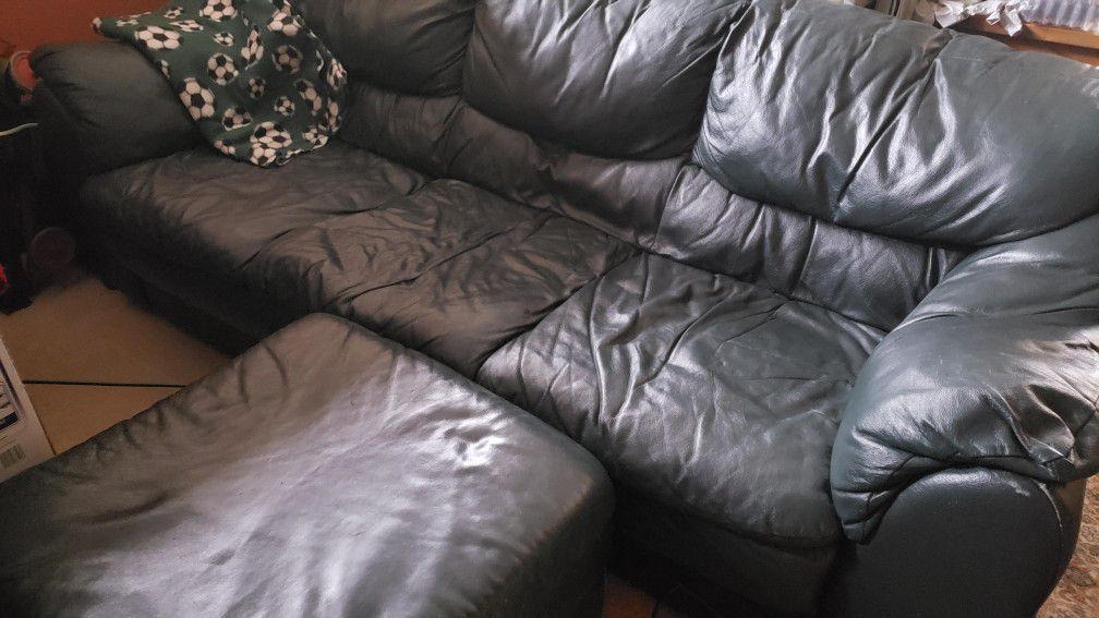 Dark green leather couch with ottoman