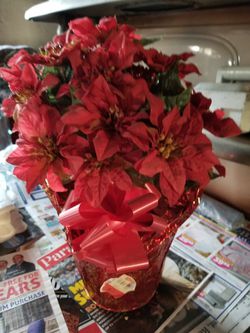 Artificial red poinsettia potted plant.