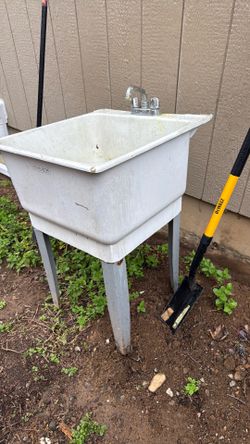 Utility tub with faucet