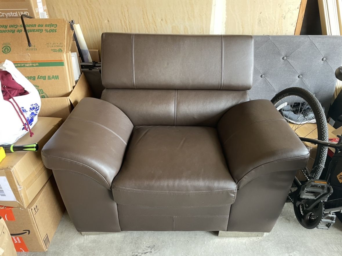 brown leather one seat couch (adjustable headrest)