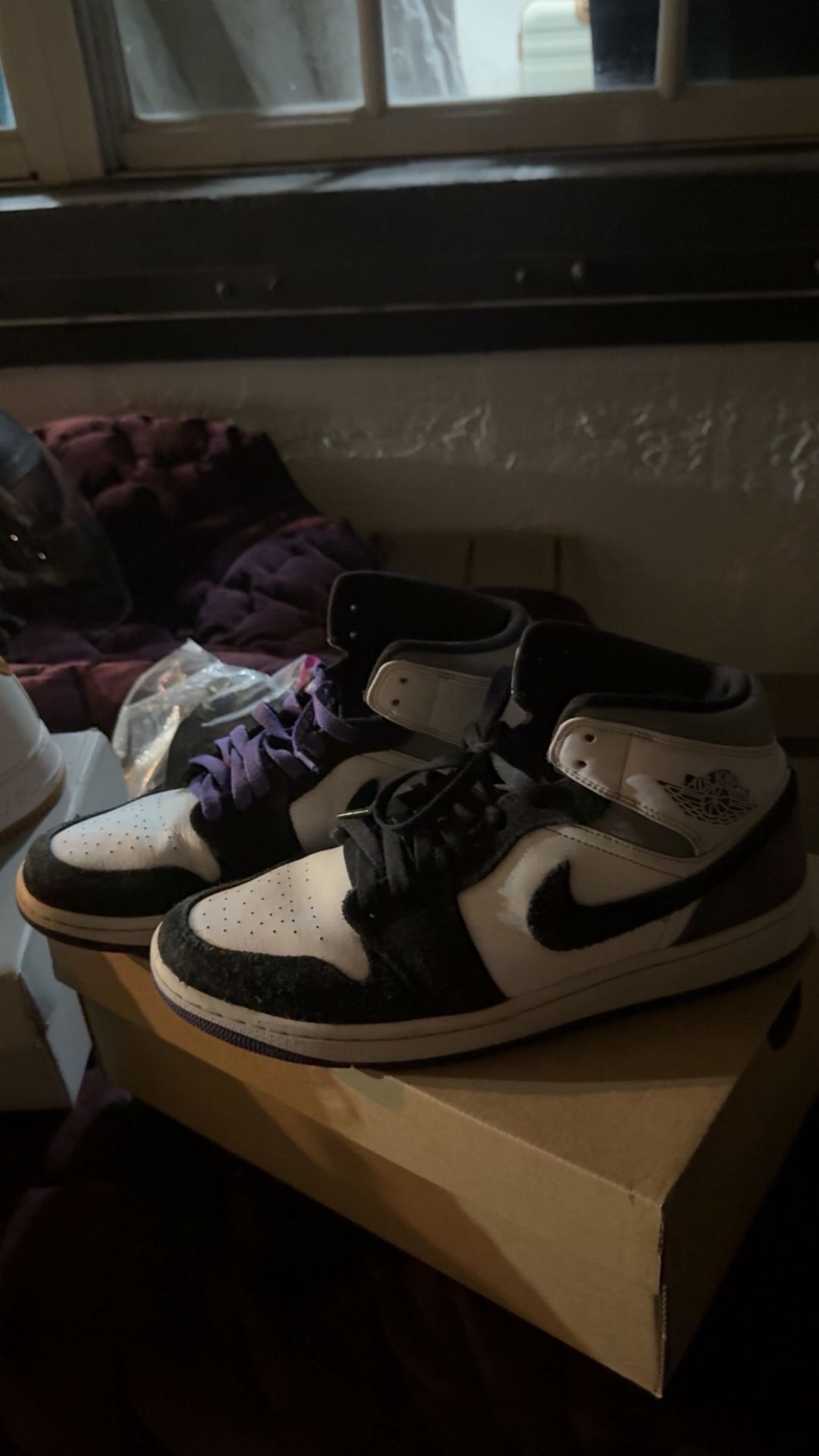 Air Jordan 1 Mid SE in a white, black, and varsity purple colorway