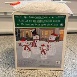 Set of 4 snowmen with LED lights, perfect for holiday decoration.