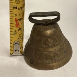 Antique bronze bell with a house, a man and a cow