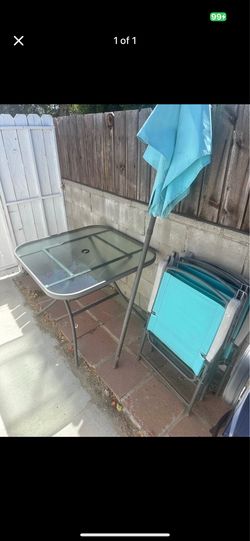 Outdoor table with 4 chairs and umbrella